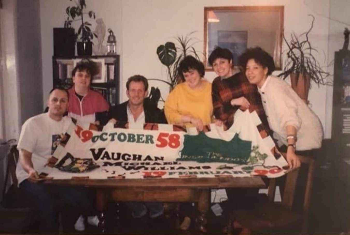 The friends of Vaughan Michael Williams, with the panel they made in his memory.