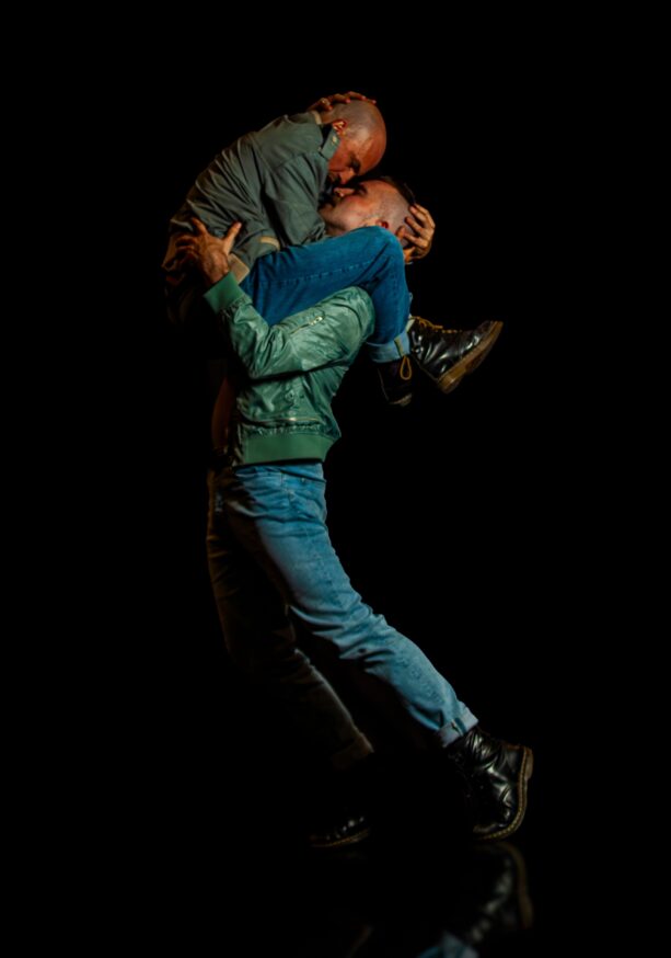 DETENTION: Two men kissing, one holding the other on his shoulders