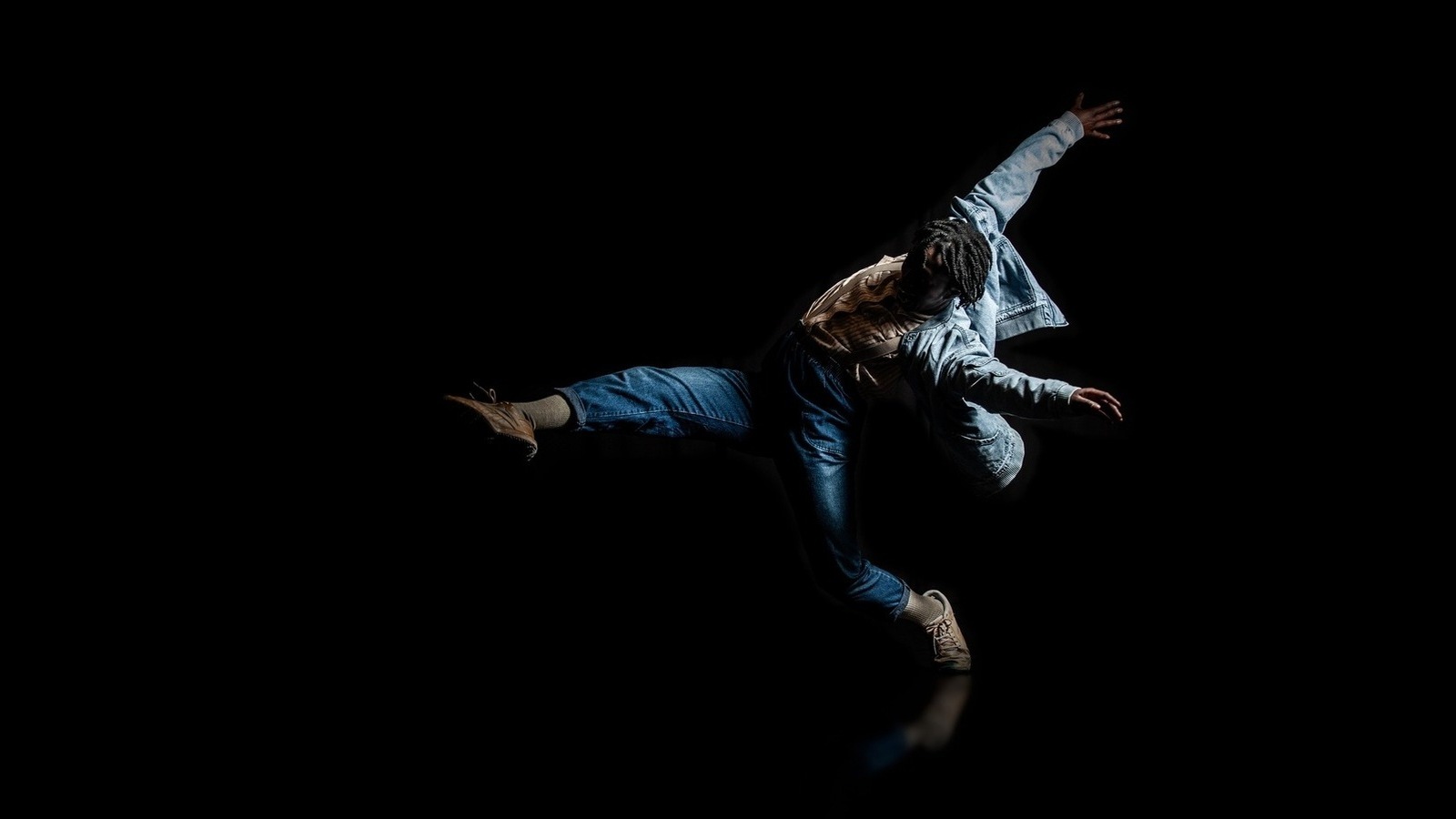 DETENTION Mayowa solo reach Black dancer in jeans and denim jacket, with leg kicked up in front and arms raised behind
