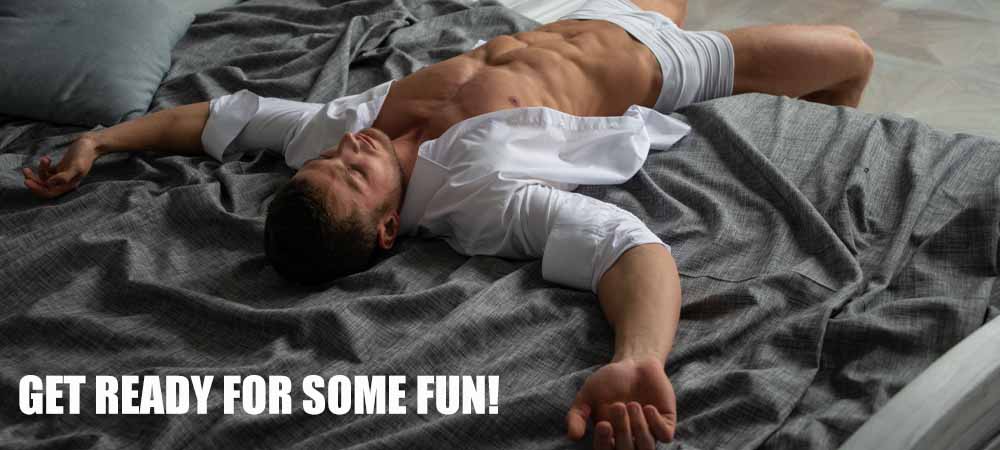 The title is ¨get ready to have some fun. There is a very sexy half dressed man lying on a bed.